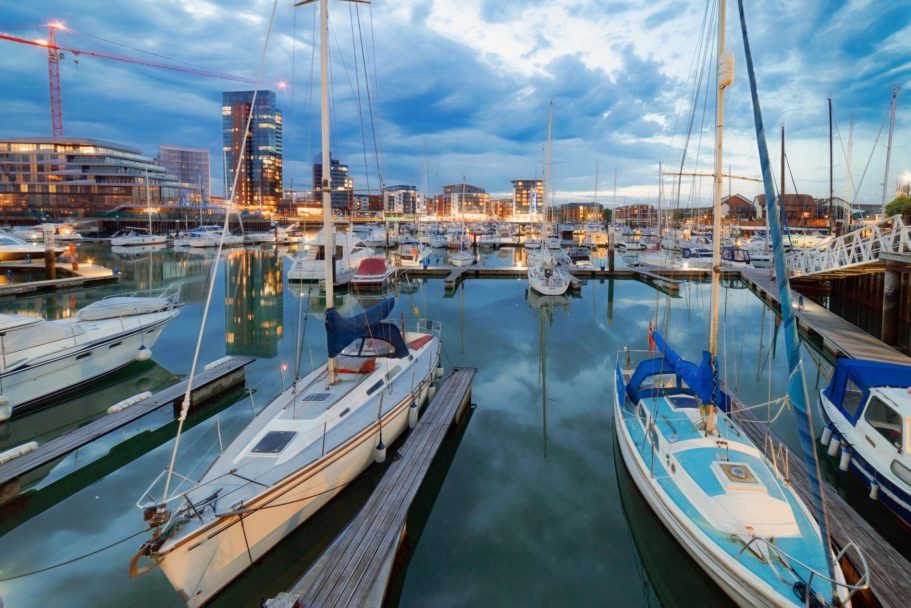 Southampton | Direct Cremations Marina at dusk with boats docked and city buildings in the background.